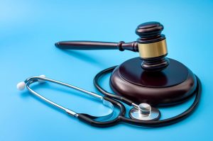 A gavel and stethoscope placed side by side, symbolizing healthcare legislation, medical malpractice rulings, and personal injury legal representation. 