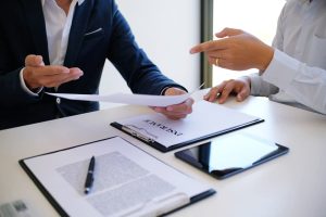 A sales manager providing guidance on completing an application form, evaluating mortgage loan options, and discussing car and home insurance offers.