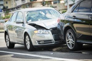 Street car crash accident with damaged vehicles.