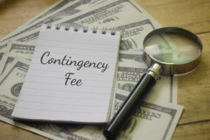 Contingency Fee concept with a magnifying glass and money, symbolizing financial agreements in legal cases.