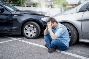 A man experiences pain following a car crash injury.