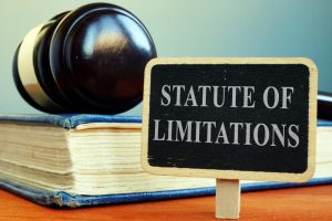 A sign displaying the statute of limitations, accompanied by a book and gavel symbolizing legal proceedings.