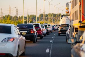 Heavy traffic jams on a highway during the holiday season, showing cars leaving the city for a weekend getaway.