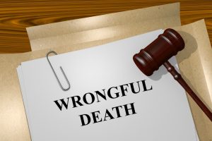 The illustration of a legal document titled "Wrongful Death" with a judge's gavel beside it, symbolizing legal proceedings.