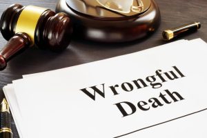 A wrongful death report sits on a courtroom desk beside a judge's gavel, symbolizing legal action and justice.